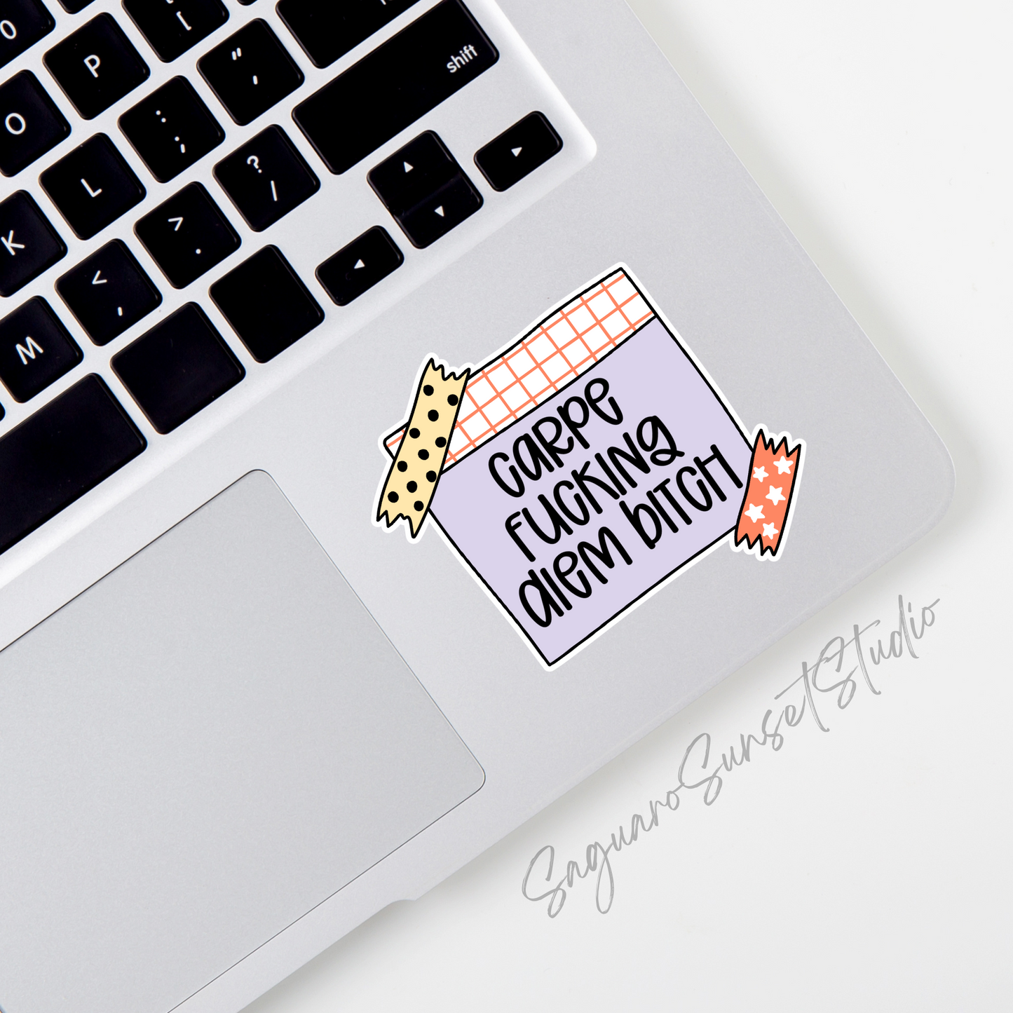 A sticker featuring the text "Carpe Fucking Diem Bitch" written on a purple sticky note with decorative tape at the corners, combining motivational vibes with bold attitude.