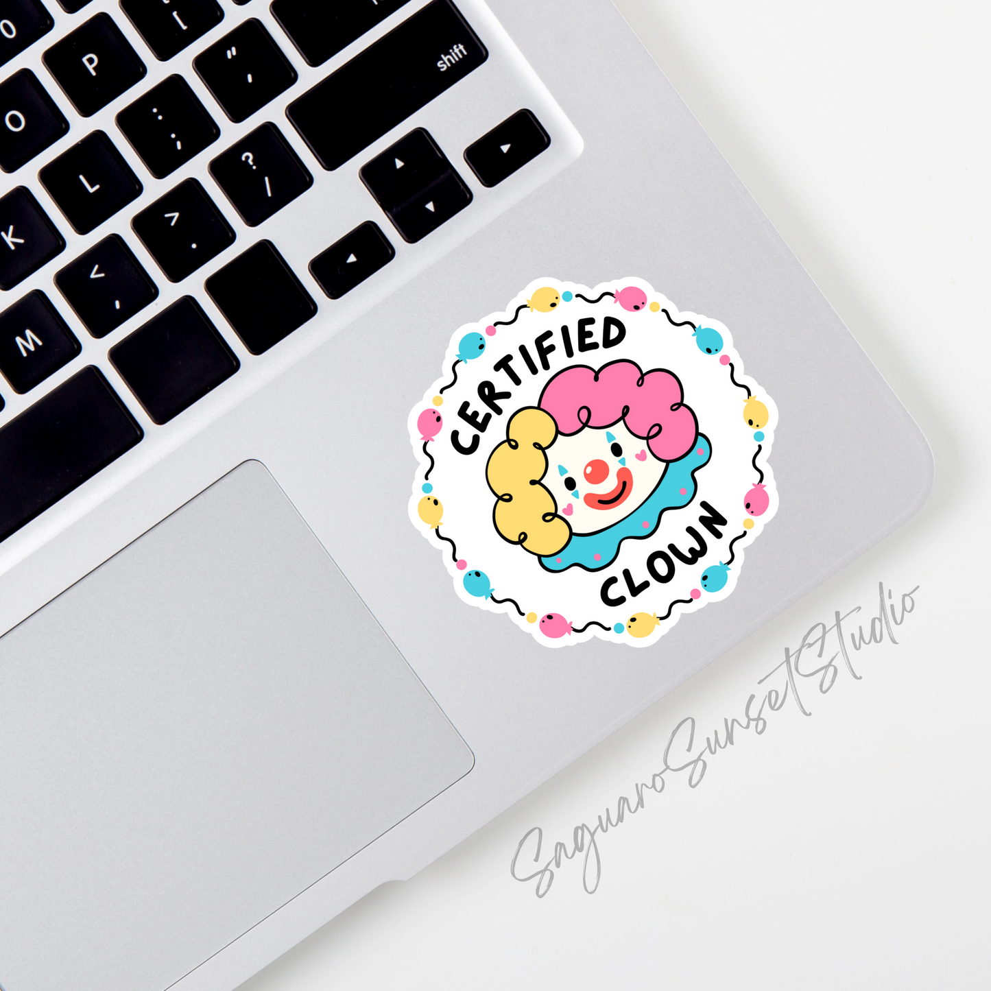 A sticker featuring a colorful clown face with yellow and pink hair, surrounded by a playful balloon border and the text "Certified Clown" in bold lettering.