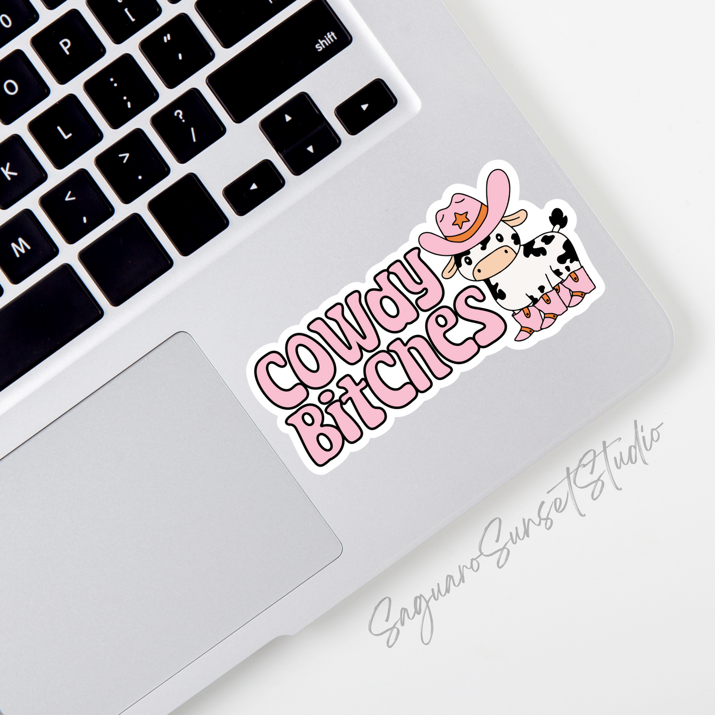 Sticker featuring a cartoon cow in a pink cowboy hat and boots with the phrase "Cowdy Bitches" in bold pink letters.