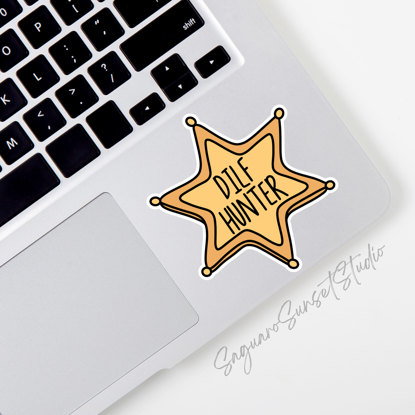 A gold, cartoon-style sheriff badge with bold black text in the center that reads “DILF HUNTER.” The badge has six rounded points with small circles at each tip, outlined in black.