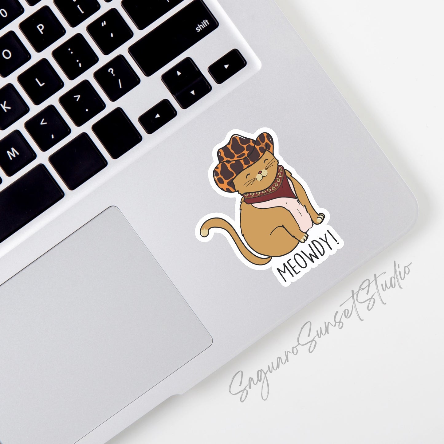 Sticker featuring an adorable cat wearing a cowboy hat and bandana with the text "Meowdy."