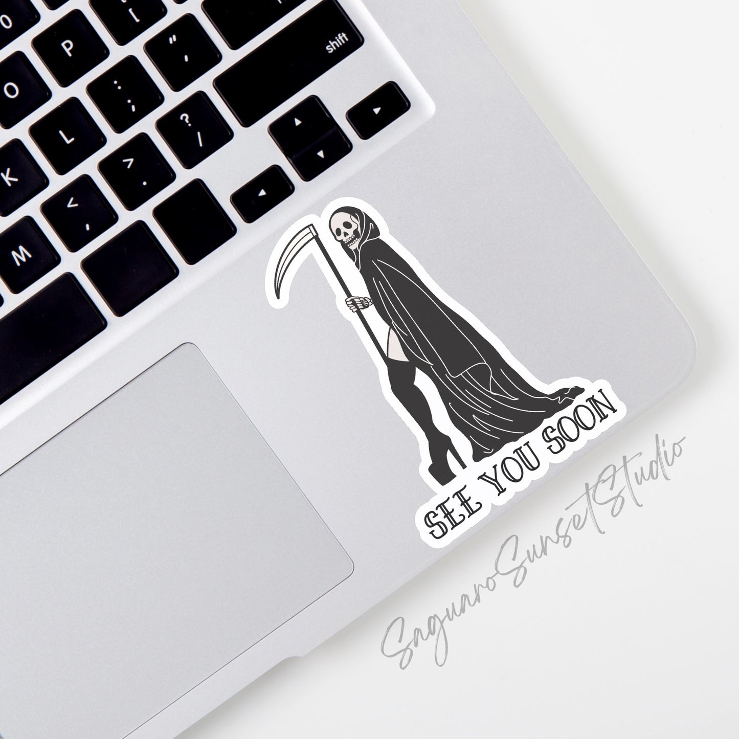 Sticker featuring a sexy Grim Reaper holding a scythe with the phrase "See You Soon," designed to add dark humor to personal items.