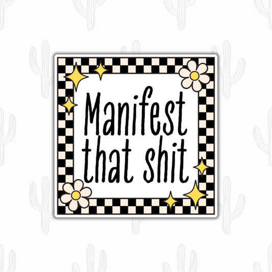 A motivational sticker that says 'manifest that shit' with a black and cream color checkered border with retro star and flower accents.