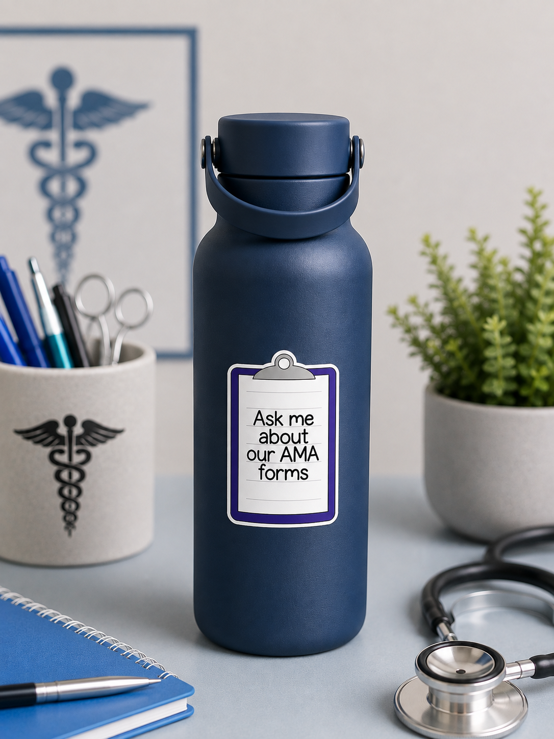 A matte navy blue insulated water bottle with a carrying loop lid, standing on a desk. The bottle has a white clipboard-style label that reads, 'Ask me about our AMA forms.