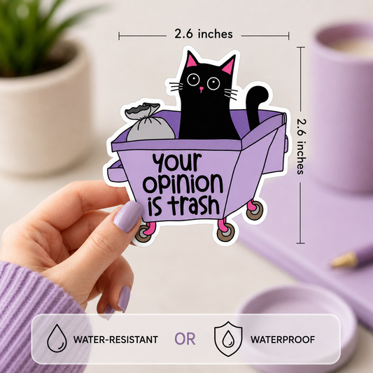 A hand holds a die-cut sticker featuring a black cat sitting in a lavender trash can with the text 'your opinion is trash'. The image includes dimension markers showing the sticker is 2.6 inches wide by 2.6 inches tall