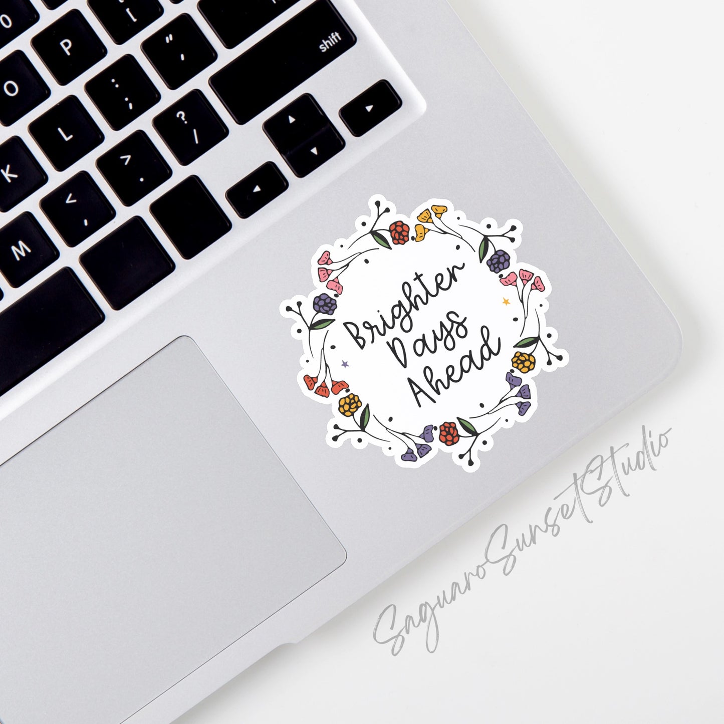 A motivational sticker with the phrase "Brighter days ahead" in cursive, surrounded by a floral frame.