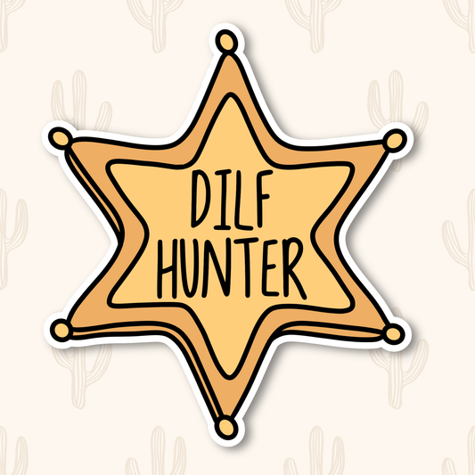 A gold, cartoon-style sheriff badge with bold black text in the center that reads “DILF HUNTER.” The badge has six rounded points with small circles at each tip, outlined in black.