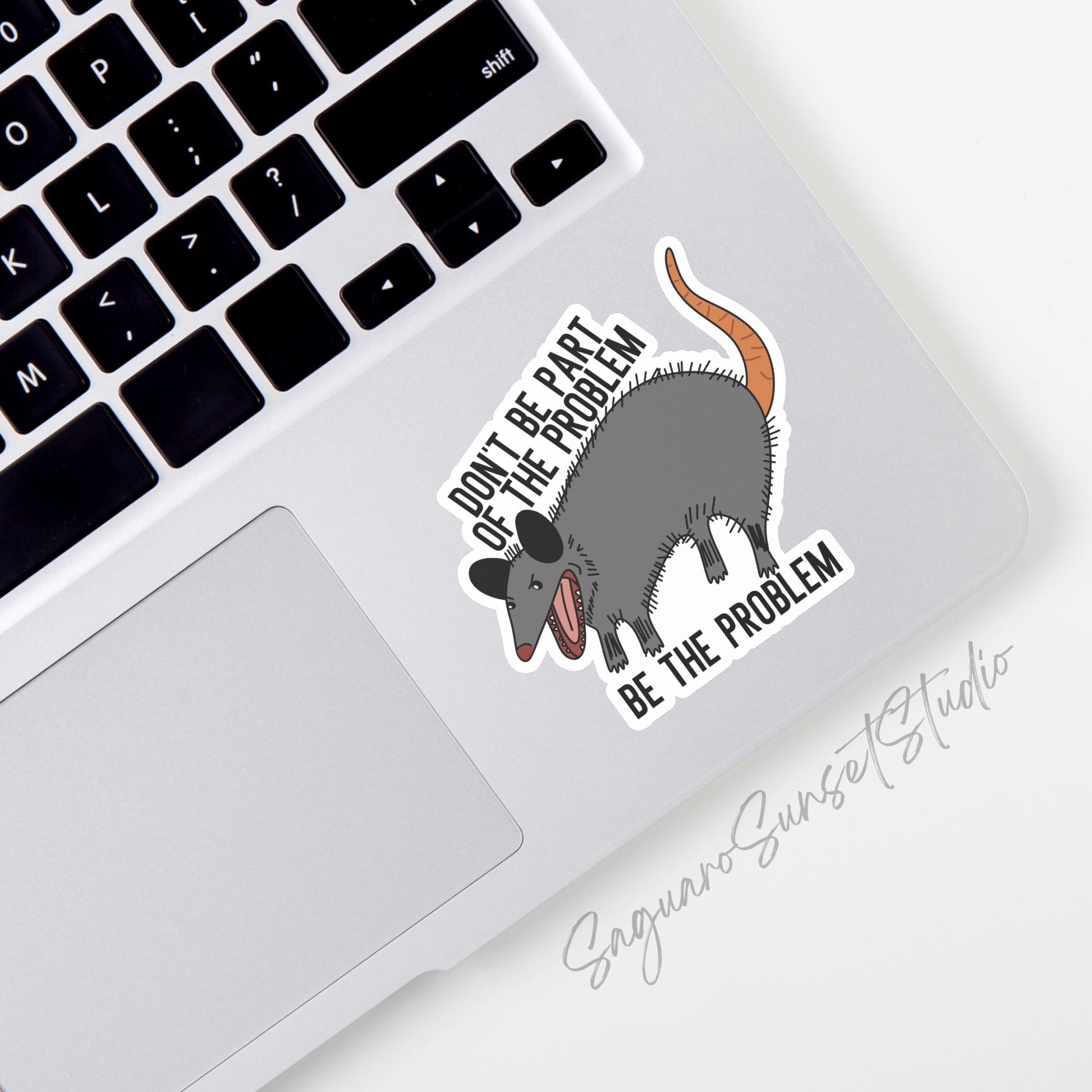 A vinyl sticker featuring the phrase "Don't Be Part of the Problem, Be the Problem" with an illustration of a possum