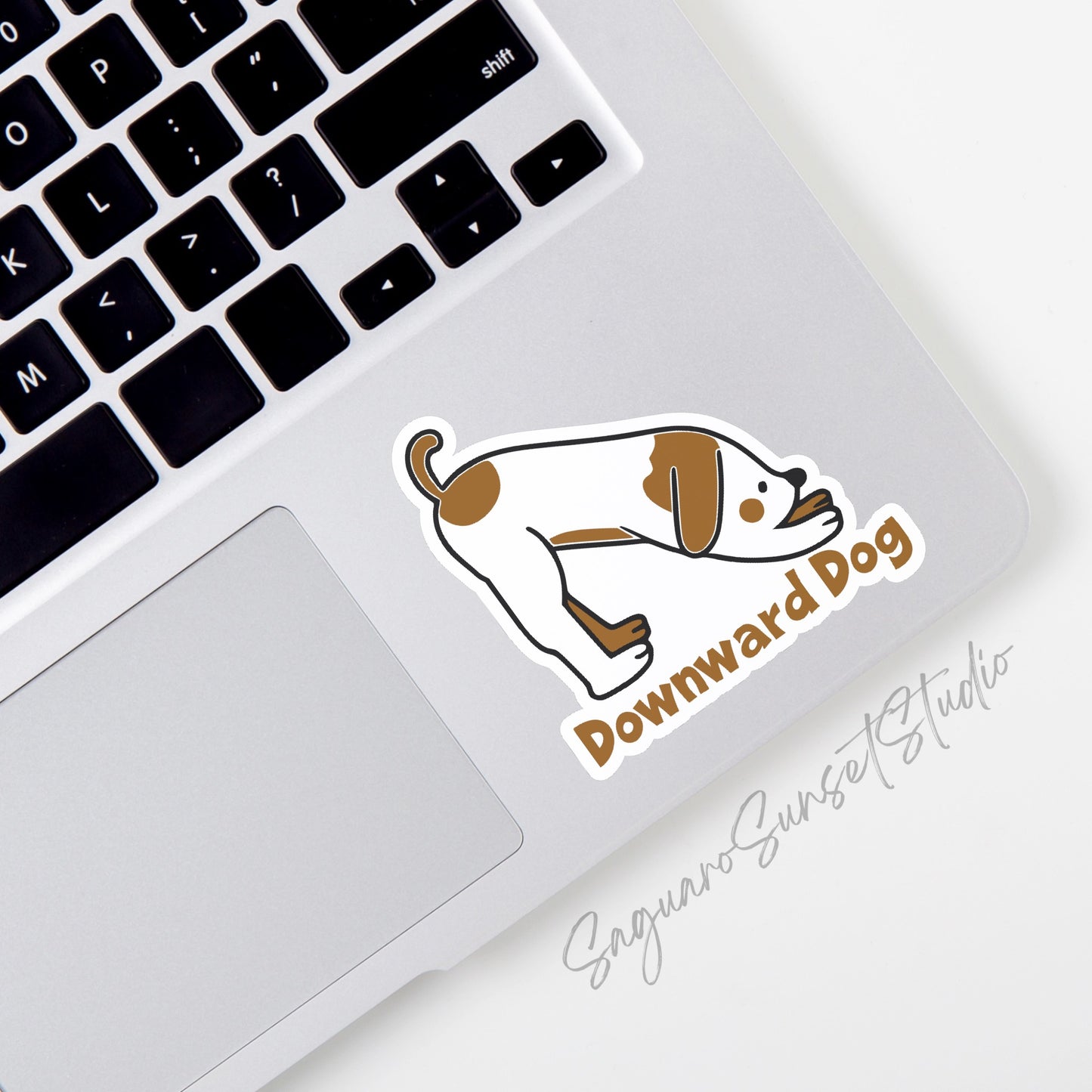 A vinyl sticker featuring a cartoon illustration of a dog in the downward dog yoga pose, with the text "Downward Dog" below the image.