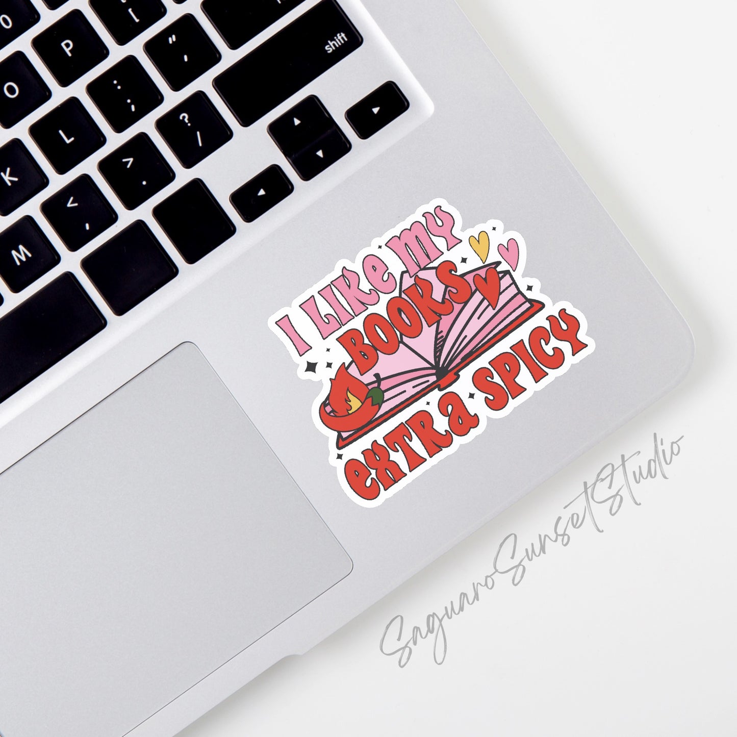 Sticker with the text "I Like My Books Extra Spicy" featuring an open book with a flame and colorful hearts. 