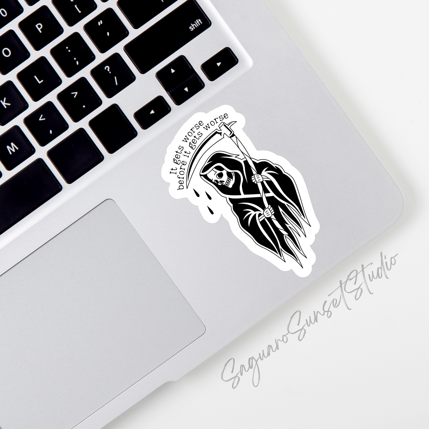 Black and white sticker on the bottom corner of a laptop featuring a grim reaper with the text 'It gets worse before it gets worse,' 