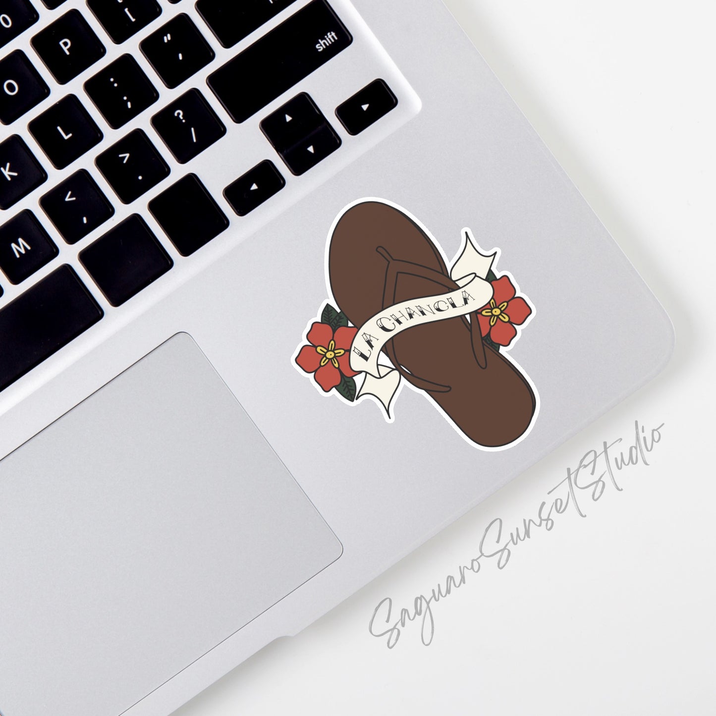 Sticker featuring a sandal with the text "La Chancla" and bright floral accents. 