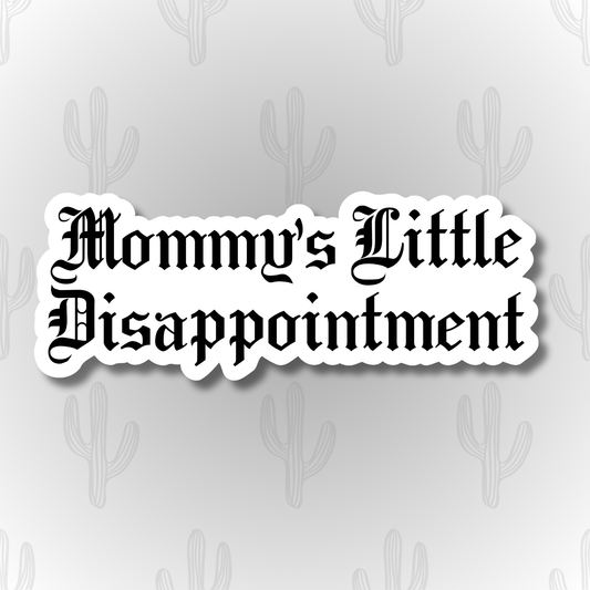 A white vinyl sticker with the phrase “Mommy’s Little Disappointment” written in bold black Gothic-style lettering.