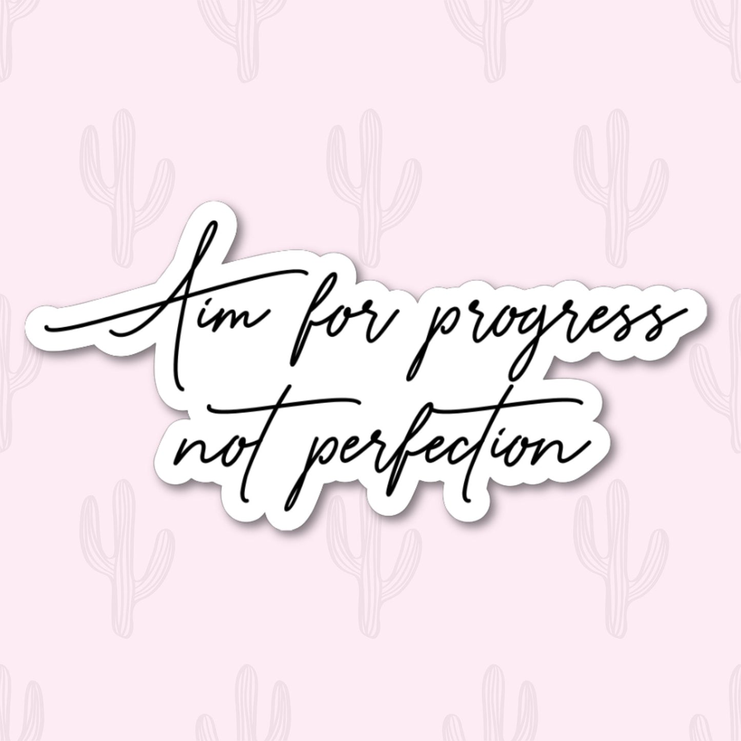 A motivational sticker featuring the phrase 'Aim for Progress not Perfection' in a minimalist cursive design