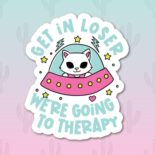 A sticker with an alien cat in a UFO with the phrase 'Get in loser we're going to therapy'