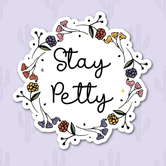 Sticker with the phrase "Stay Petty" surrounded by colorful floral accents, perfect for adding a touch of sass to your items.