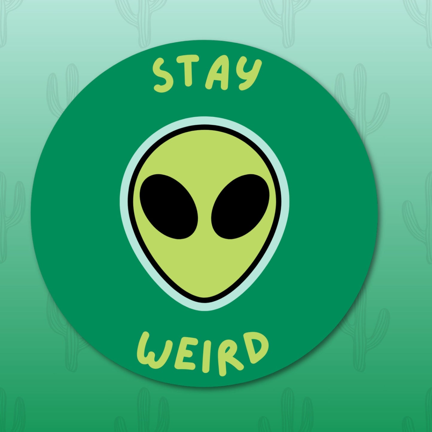 Circular sticker with an alien face and the phrase "Stay Weird," perfect for adding a touch of uniqueness to your belongings.