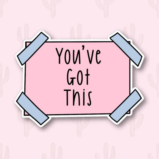 A sticker with the phrase "You've Got This" written in black text on a pink rectangular background. The sticker has blue tape corners.