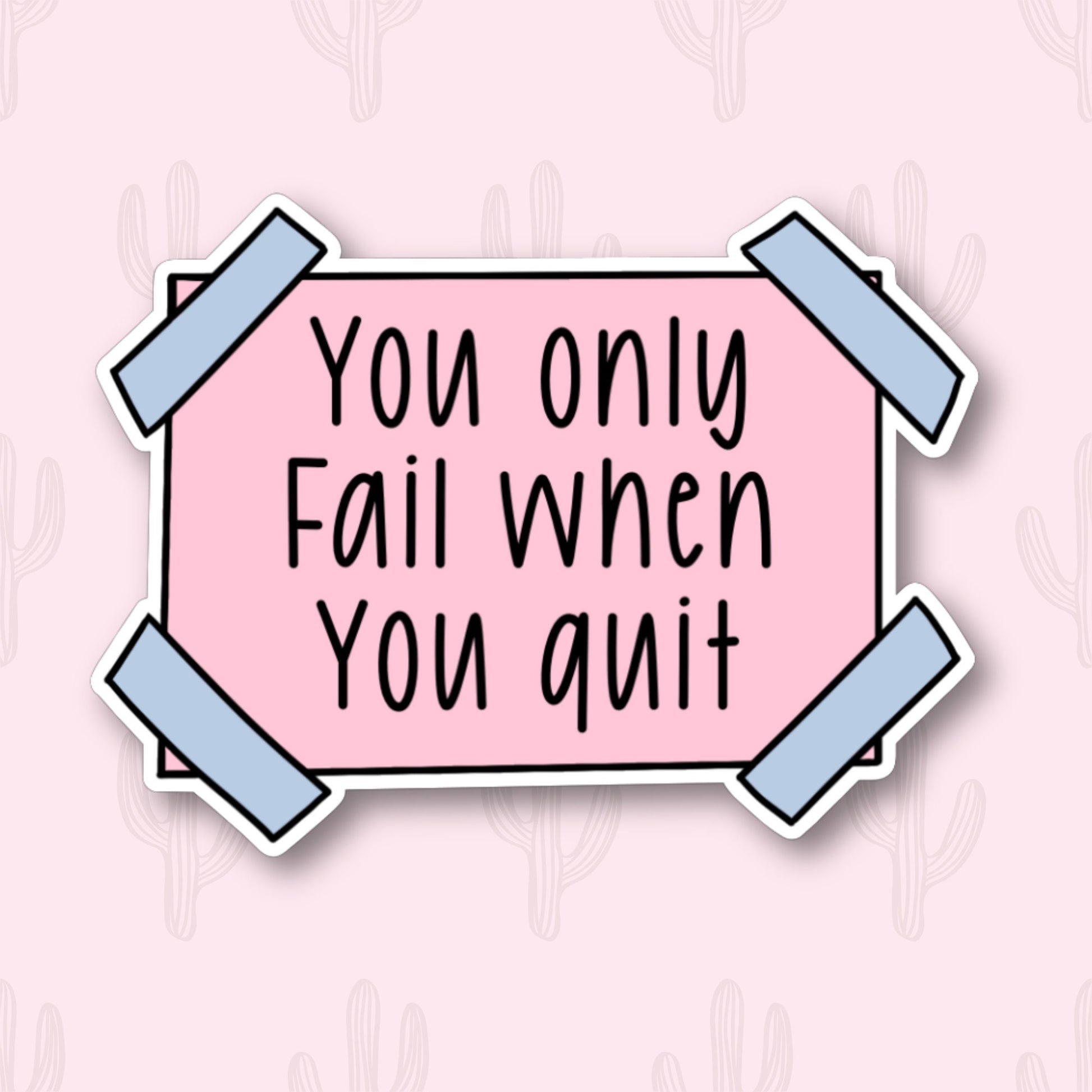 A sticker with the motivational phrase "You only fail when you quit" written in black text on a pink rectangular background. The sticker has blue tape corners.