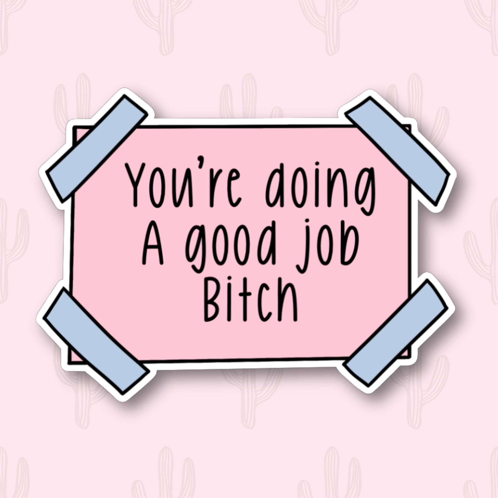 A sticker with the phrase "You're doing a good job, Bitch" written in black text on a pink rectangular background. The sticker has blue tape on each corner.