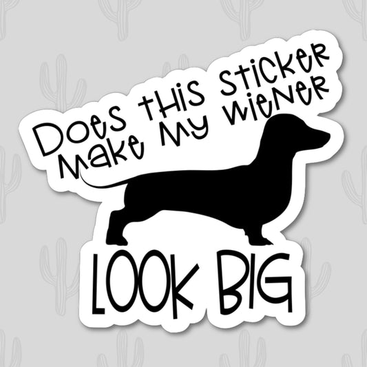 A vinyl sticker with the humorous phrase "Does This Sticker Make My Wiener Look Big?" featuring a black silhouette of a dachshund