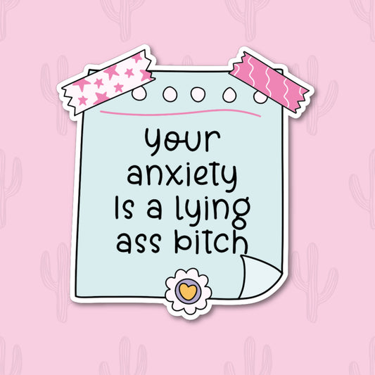 A sticker with the phrase "Your anxiety is a lying ass bitch" written in black text on a light blue notepad-style background. The sticker is decorated with pink star and wave-patterned tape and a small heart embellishment at the bottom. 