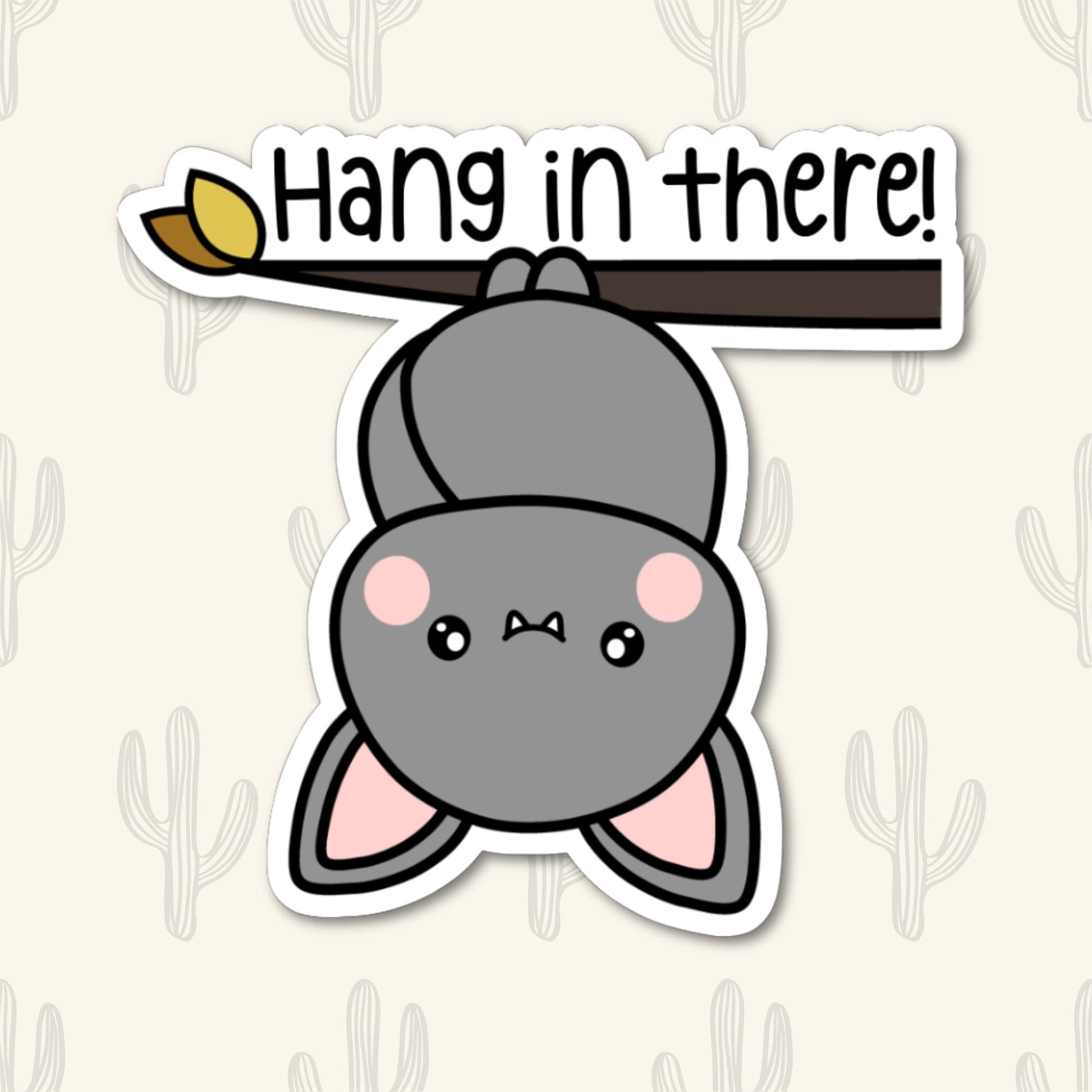 A vinyl sticker featuring a cute bat hanging upside down from a branch with the phrase "Hang in There!" written above