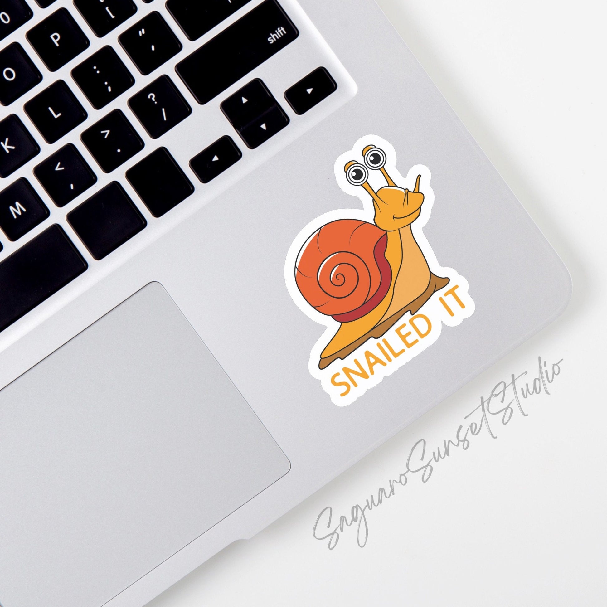 Sticker featuring a happy orange snail with the phrase "Snailed It," designed to add humor and celebrate achievements.