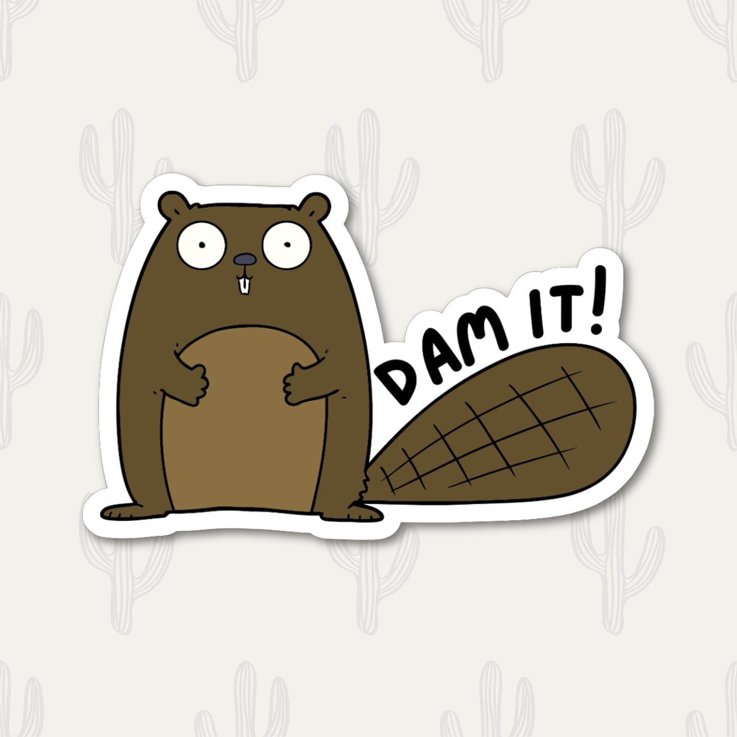 A sticker featuring a cute cartoon beaver with a large tail and the phrase "Dam It!" written in black text. 