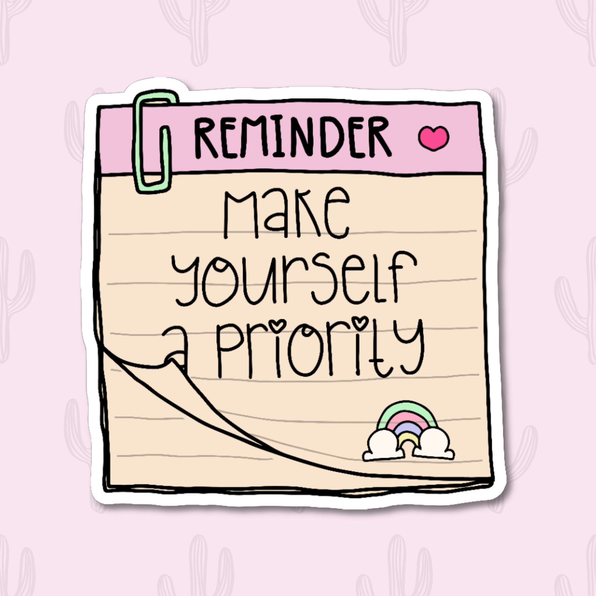 A sticker featuring a notepad with a pink header labeled "Reminder" and a heart icon, with the phrase "Make Yourself a Priority" written below. The design includes a cute paperclip and a small rainbow at the bottom. 